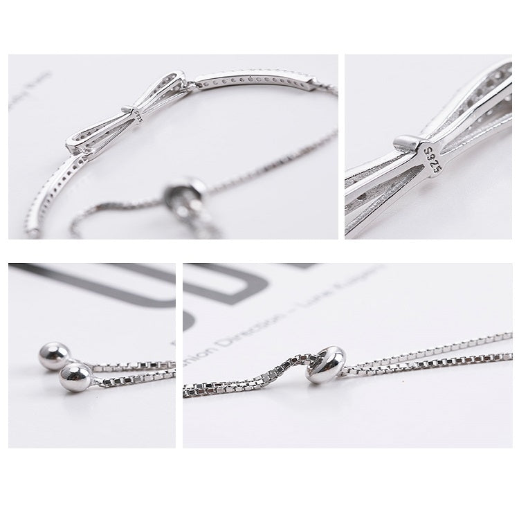 Silver bracelet clasp and bow detail with bead chain