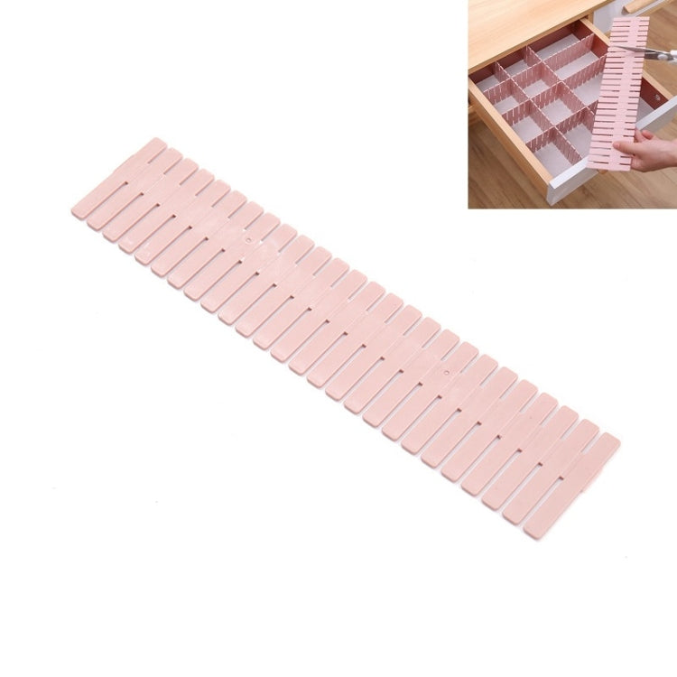 Pink plastic drawer divider strip with multiple slots, long organizer insert