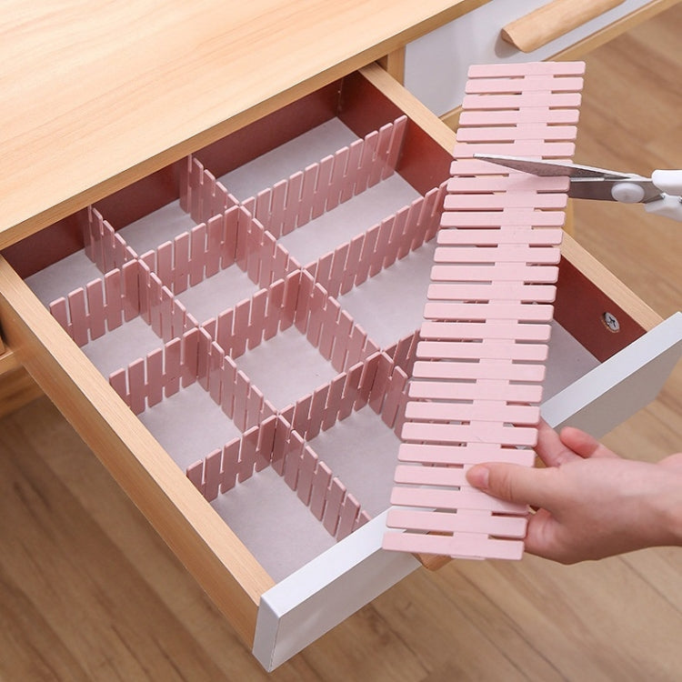 Pink plastic drawer divider set forming a grid inside a drawer organizer