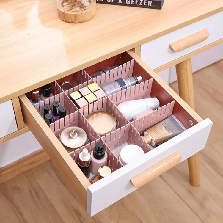 Pink plastic drawer dividers with compartment slots for bottles and small accessories
