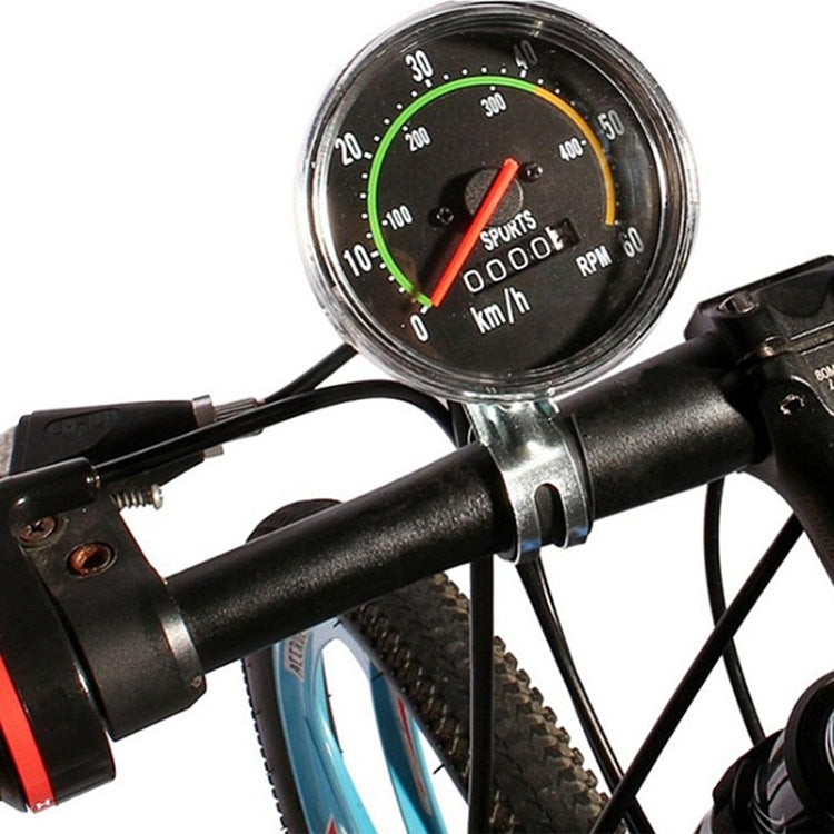 Round mechanical bicycle speedometer with km/h and RPM dials on handlebar