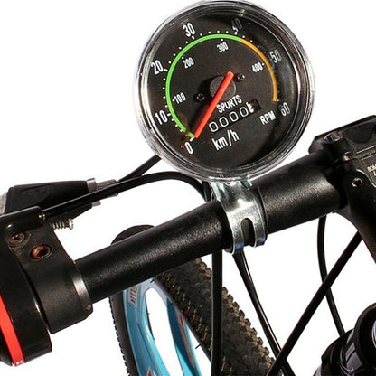 Round mechanical bicycle speedometer with km/h and RPM dials on handlebar