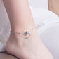 Delicate girls anklet with thin chain and small blue zircon round charm