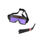 Black welding goggles with adjustable head strap and purple tinted viewing lens