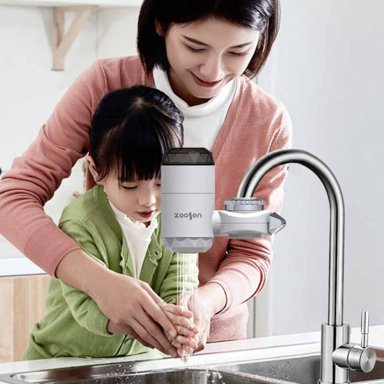 Electric instant hot water faucet dispensing water at a kitchen sink for family use