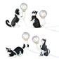 Set of cat figurine mini night light table lamps with glowing bulbs, dark gray and white cats