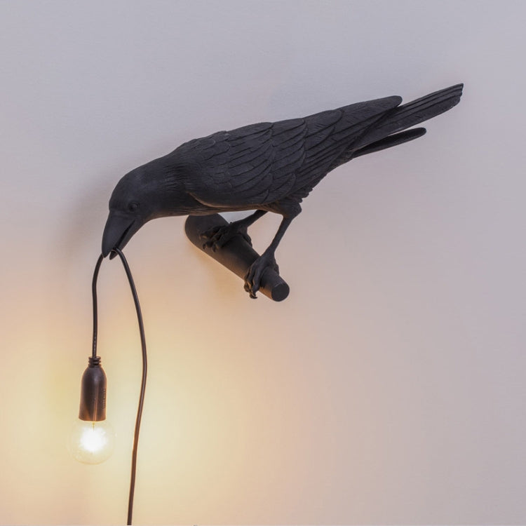 Black bird wall lamp with hanging E14 bulb and curved cord