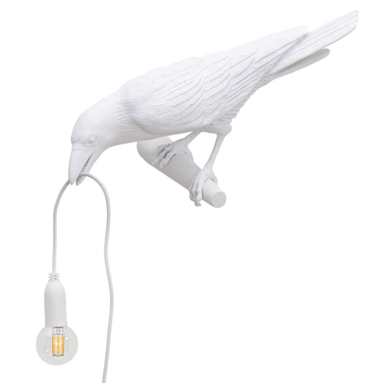 White bird wall lamp figurine with hanging bulb and exposed wire cord