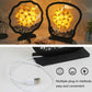 Two paper carving shadow lamps on black bases, yellow paper shades glowing with cable