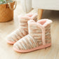 Two beige knit indoor boot slippers with pink fuzzy trim and thick pink rubber sole.