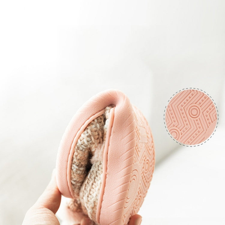 Beige knit slipper with pink lining and non-slip outsole tread pattern on the bottom.