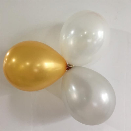 Three latex balloons: gold and two white balloons