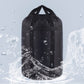 Black waterproof sleeping bag storage bag with drawstring top, shown with water droplets