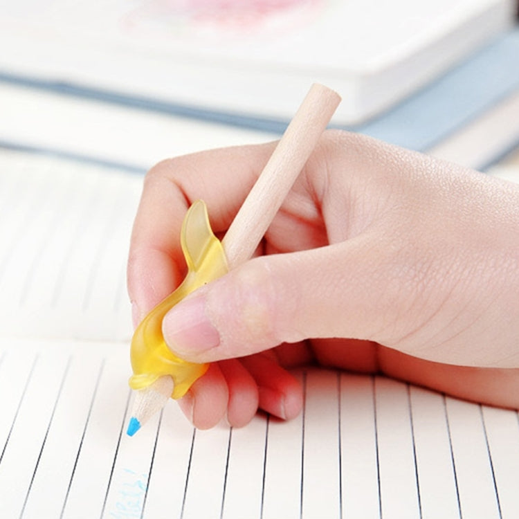 Yellow dolphin-shaped writing pen with wooden tip in hand over notebook lines