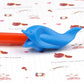 Blue dolphin-shaped posture pen lying on printed stationery paper