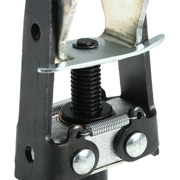 Close-up valve spring compressor showing threaded screw, spring seat, and metal base