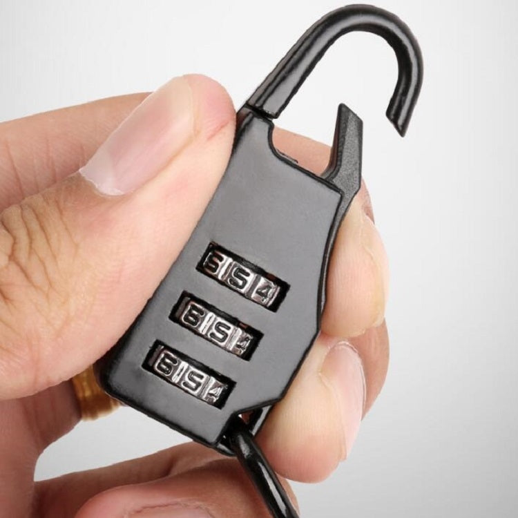 Black helmet cable lock with four-digit combination keypad held in a hand