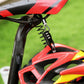 Combination cable lock attached to a red bicycle near the helmet mount with coiled cord