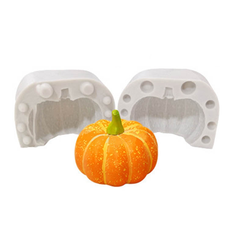Pumpkin silicone candle mold with two cavities and a molded orange pumpkin