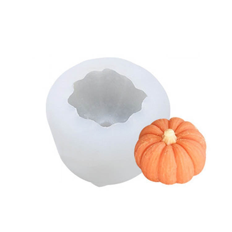 Silicone candle mold with pumpkin cavity and small orange pumpkin