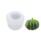 Silicone candle mold with pumpkin cavity and green-and-yellow pumpkin