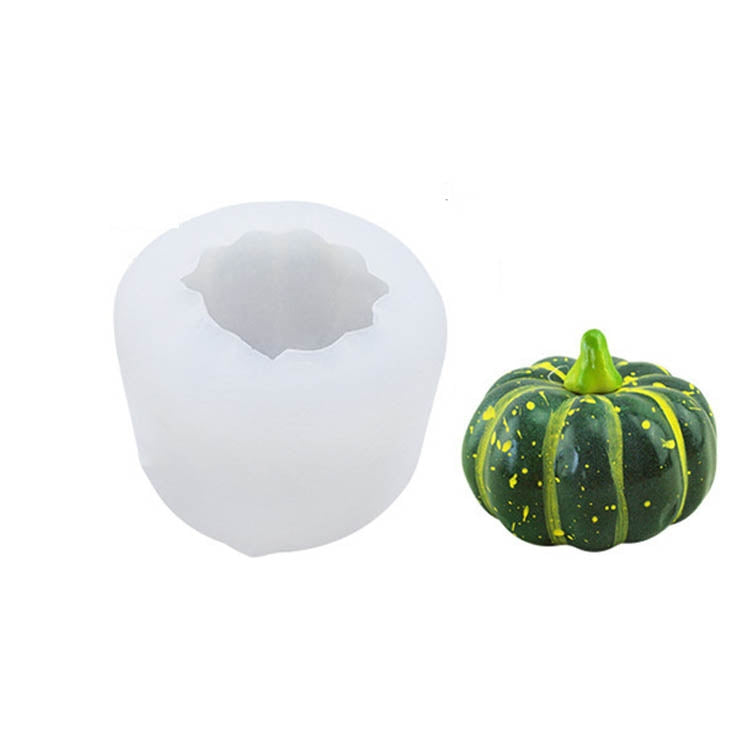 Silicone candle mold with pumpkin cavity and green-and-yellow pumpkin
