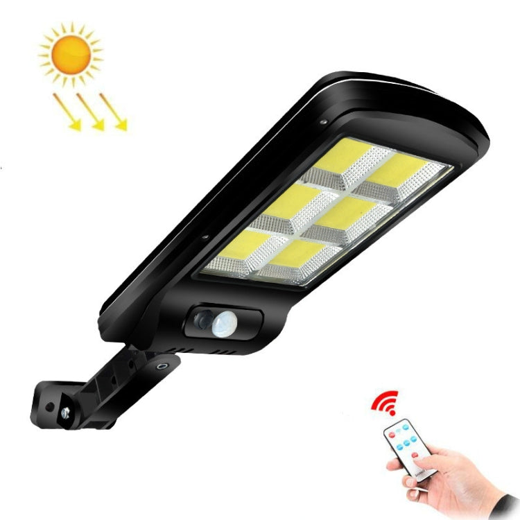 Solar street light with black LED lamp head and motion sensor, shown with remote control