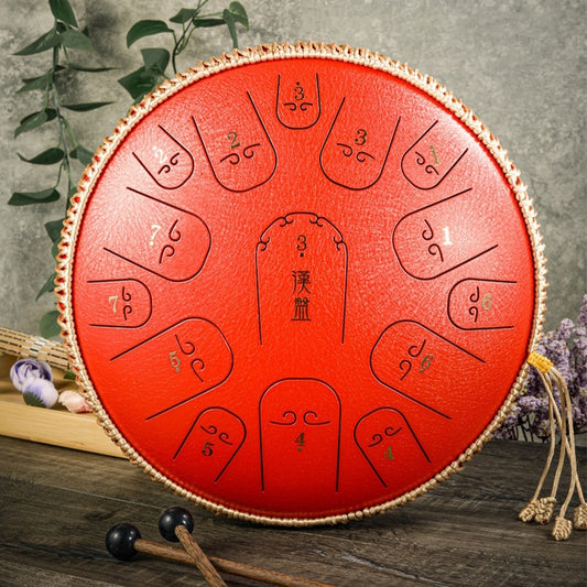 Red steel tongue drum with etched tone symbols and braided rope rim