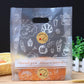 Plastic gift bag with baked with love label sticker and line-doodle icons