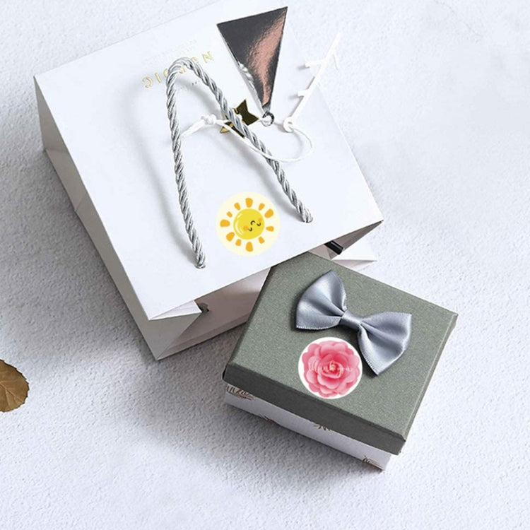 Gift boxes with small round yellow sun thank-you sticker on tied tags