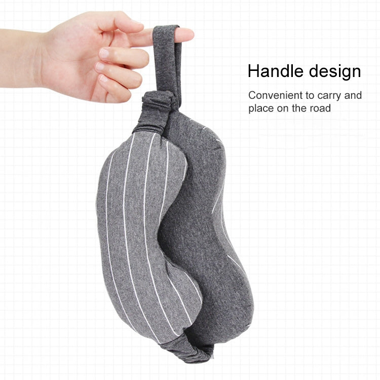 Gray travel neck pillow with attached eye mask, handheld for easy carry