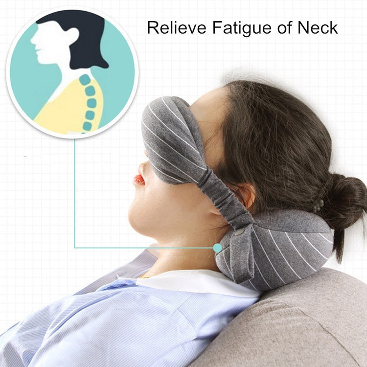 Dark gray neck pillow and attached striped eye mask on head, travel sleeping support