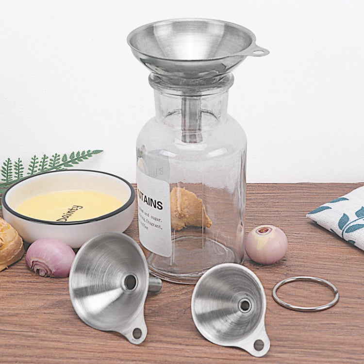 Three stainless steel mini funnels with ring, designed to fit a glass bottle neck