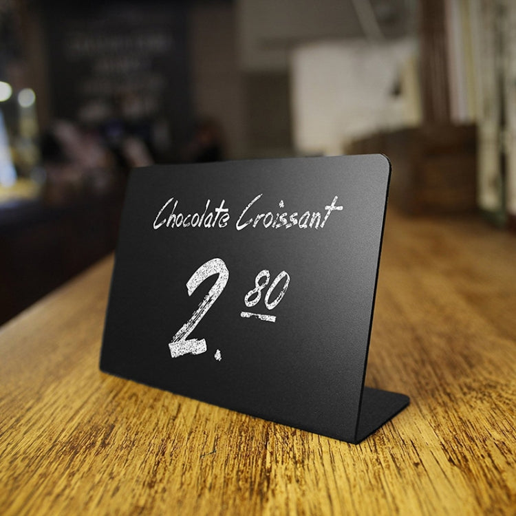 Small black desktop acrylic board with white menu text: Chocolate Croissant 2 80