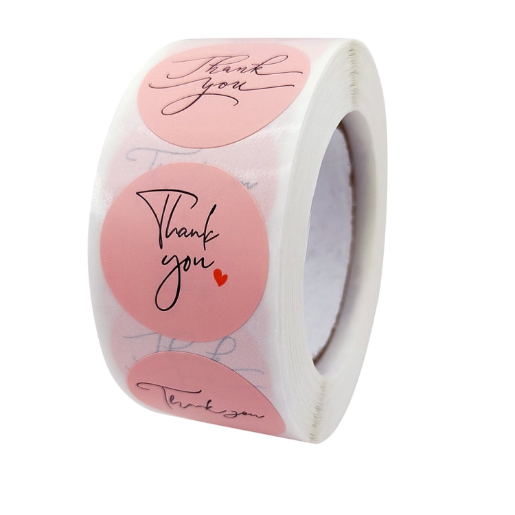 Close-up of thank you baking sticker roll with pink round labels and heart accents