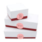 Thank you round baking stickers on stacked gift boxes with red bands