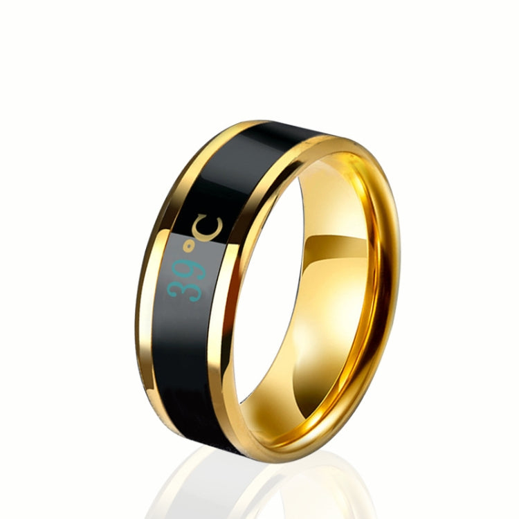 Smart temperature display ring in gold with black screen showing 39°C icon