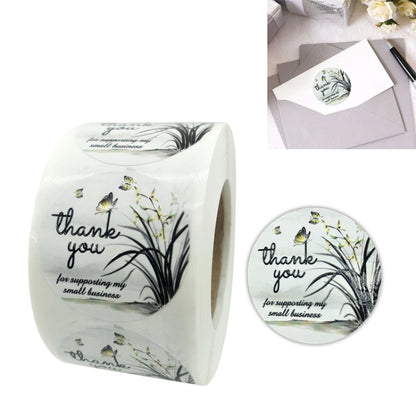 White roll of round thank-you envelope sealing stickers with floral branch and butterflies