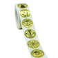 Strip of gold Christmas sticker labels on a roll, with circular “Merry Christmas” designs