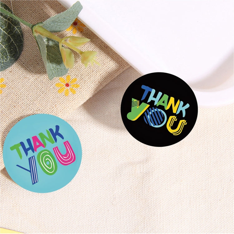 Circular Thank You stickers on fabric, including black and blue “Thank You” designs