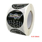 Round 'Thank you' sticker labels on a roll, black design with colorful floral accents