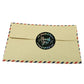 Envelope with round 'Thank you' sticker seal, black design with colorful floral border