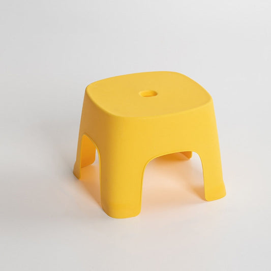 Yellow plastic low step stool with cutout handles and round top hole