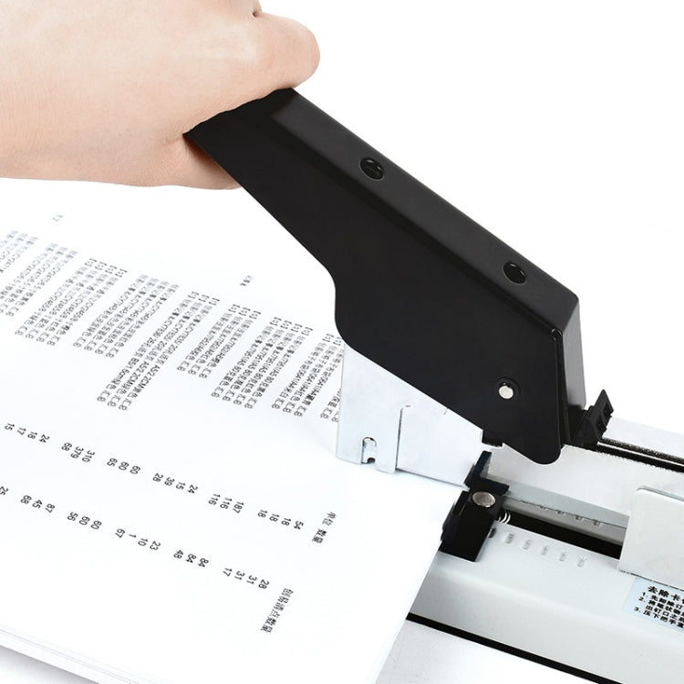 Manual stapler with black lever pressed over papers, staple feed area visible