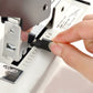 Manual stapler loading mechanism close-up, metal jaws and black upper handle