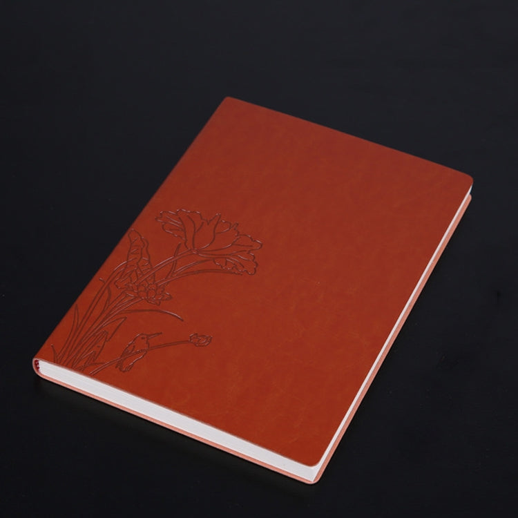 Orange PU notebook with embossed floral branch design and white page edges.