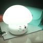 Cute white silicone mushroom night light with winking face and soft glow