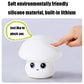 Silicone mushroom night light with hand pinching top; friendly cute face