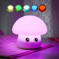 Purple silicone mushroom night light with smiling face, glowing on bedside table
