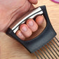 Hand holding black onion slicer fork frame with stainless steel cutting pins